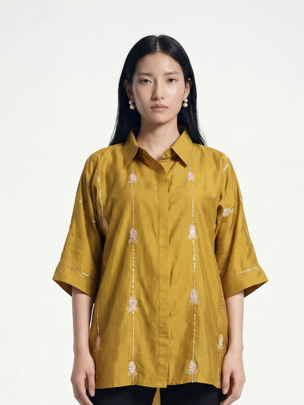 Female model wearing VUNN Dhoop Shirt — turmeric yellow silk shirt with pointed collar, button front and vertical block-printed floral detailing