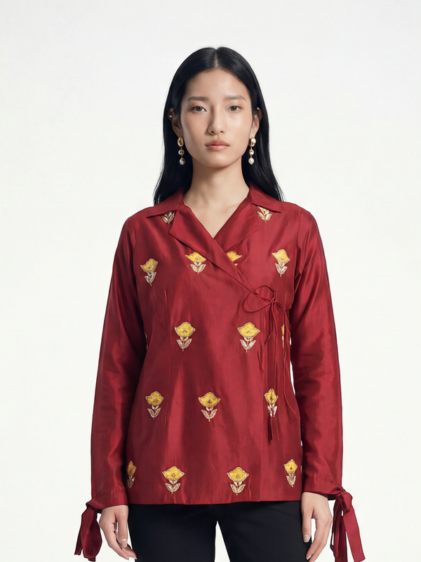 Female model wearing VUNN Fitoor Shirt — deep red silk wrap shirt with yellow hand-block floral motifs, notched lapel and bow-tie cuffs