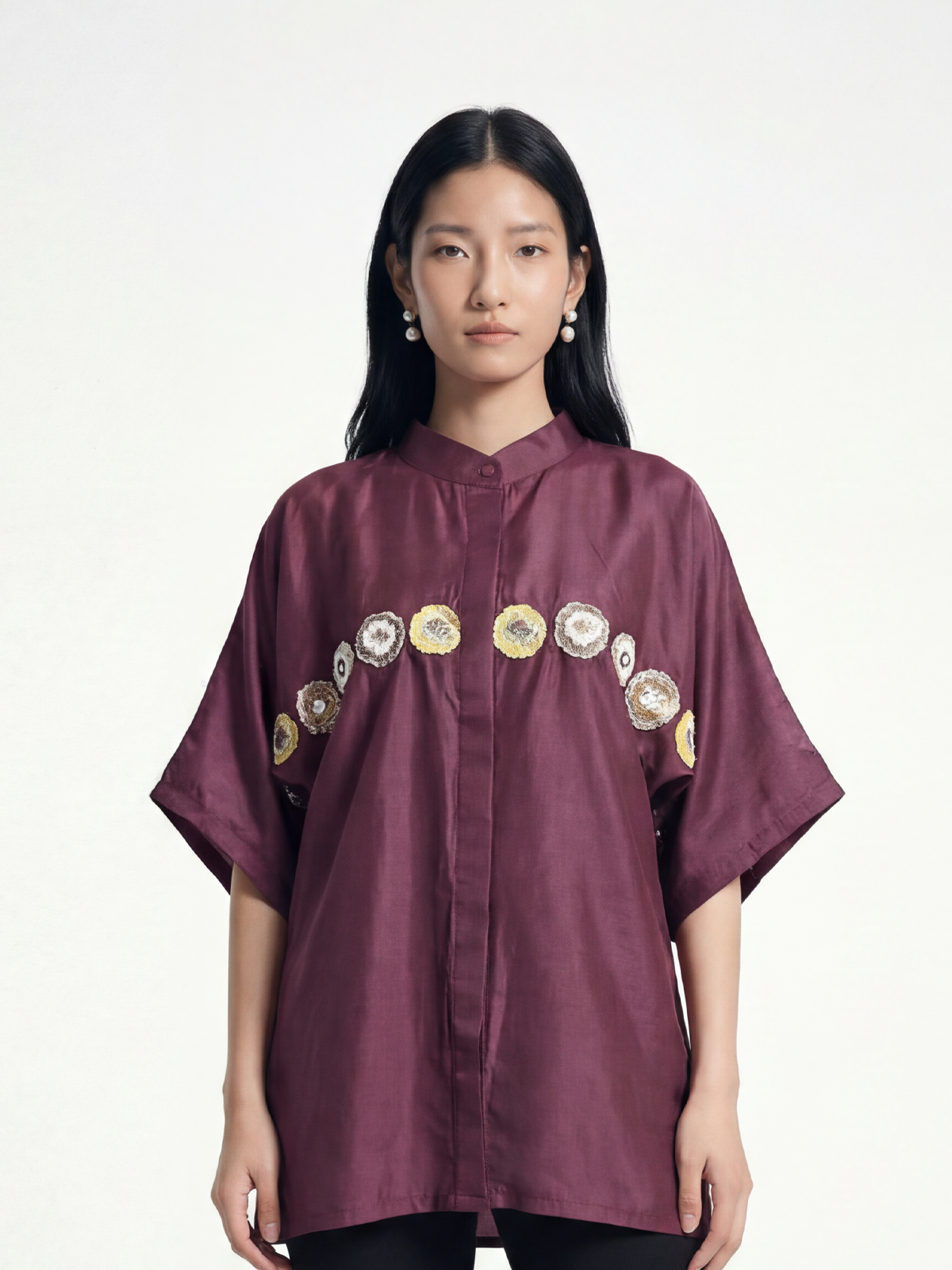 Female model wearing VUNN Phool Shirt — aubergine silk half-sleeve shirt with mandarin collar and a hand-embroidered medallion band across the chest
