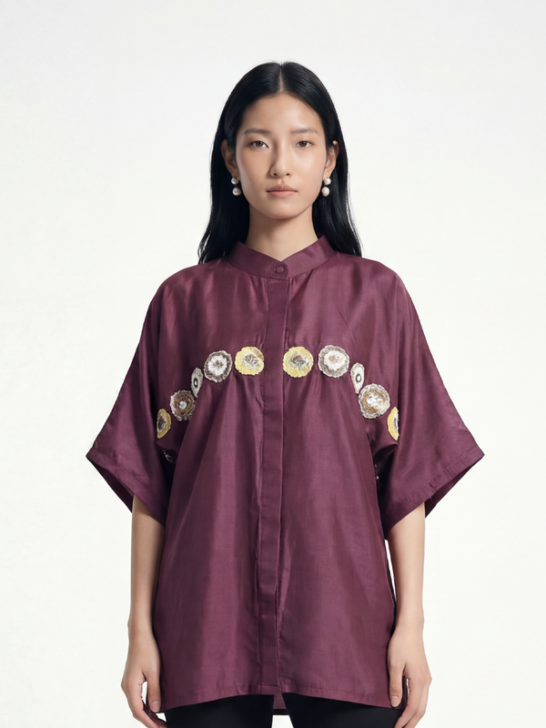 Female model wearing VUNN Phool Shirt — aubergine silk half-sleeve shirt with mandarin collar and a hand-embroidered medallion band across the chest