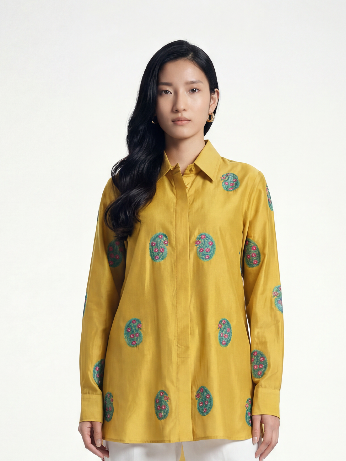 Female model wearing VUNN Saibo Shirt — oversized mustard yellow silk shirt with teal and dusty rose block-printed circular motifs