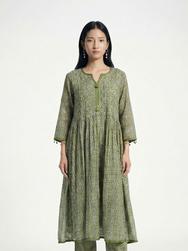 Female model wearing VUNN Varnika Kurta — sage green hand-block printed Chanderi anarkali with pintuck yoke, tasselled three-quarter sleeves and matching printed pants